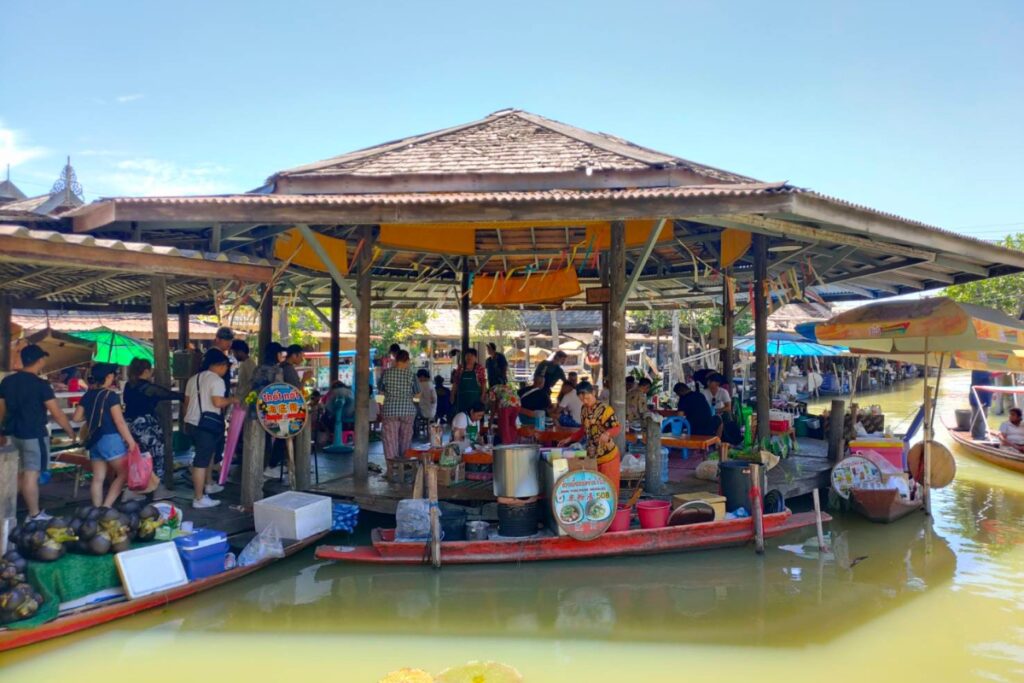 vendors selling food at floating market in pattaya