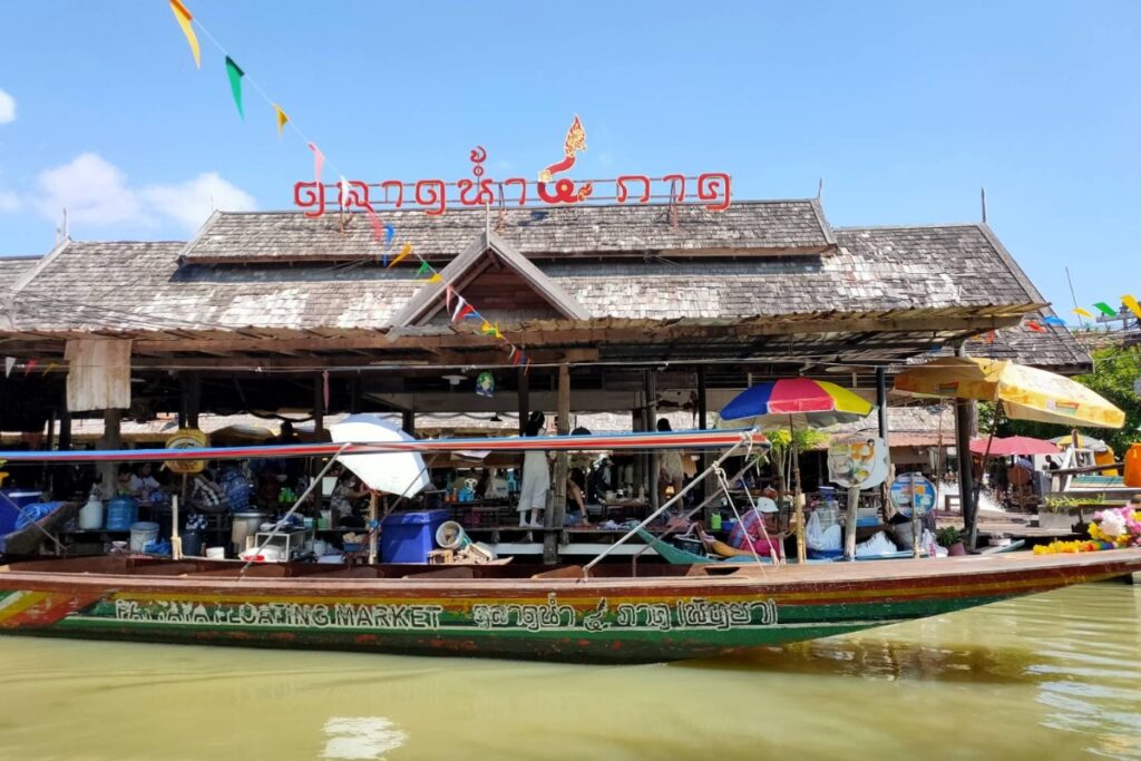 shaded long-tail boat at pattaya floating market