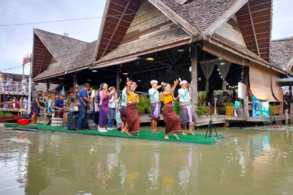 traditional dancers performing on river