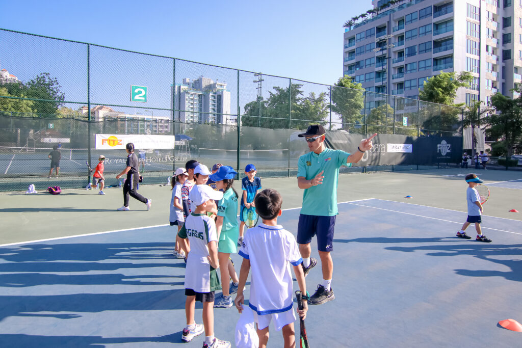 Tennis player Danai Udomchoke guiding kids at tennis tournament in Pattaya