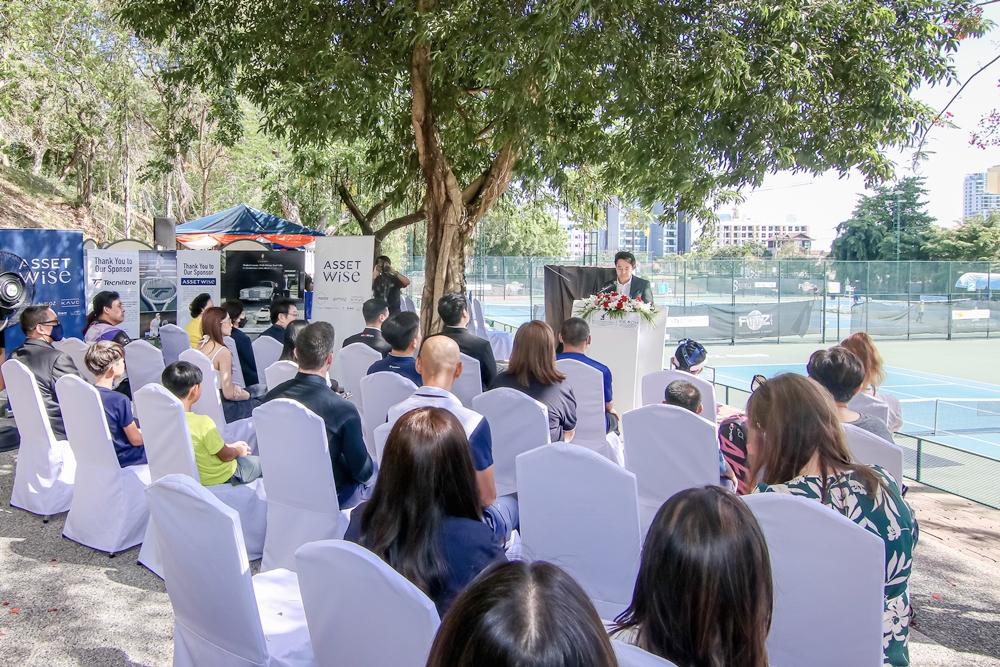 CEO delivering opening speech at tennis championship, discussing vision of Thailand as sports destination