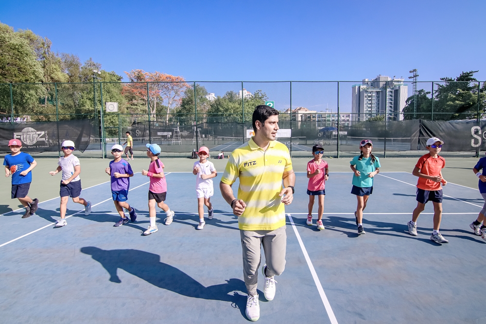 Junior tennis players training with Fitz Club coach