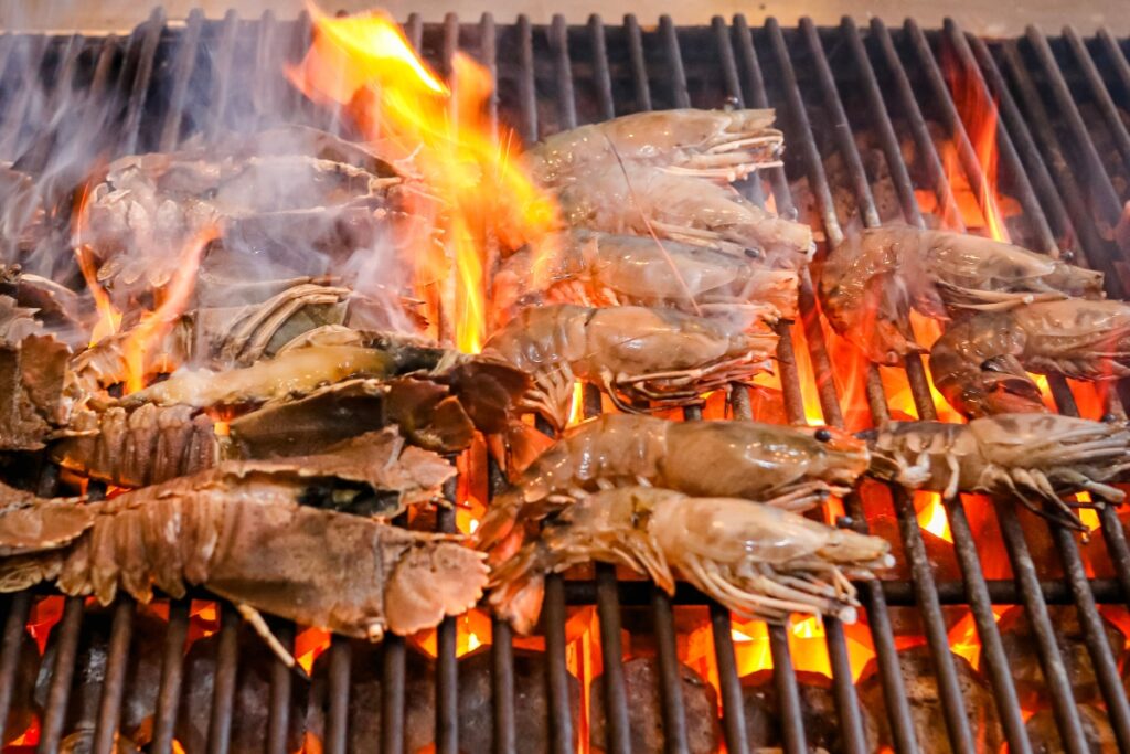 Fresh prawns grilling on an open flame