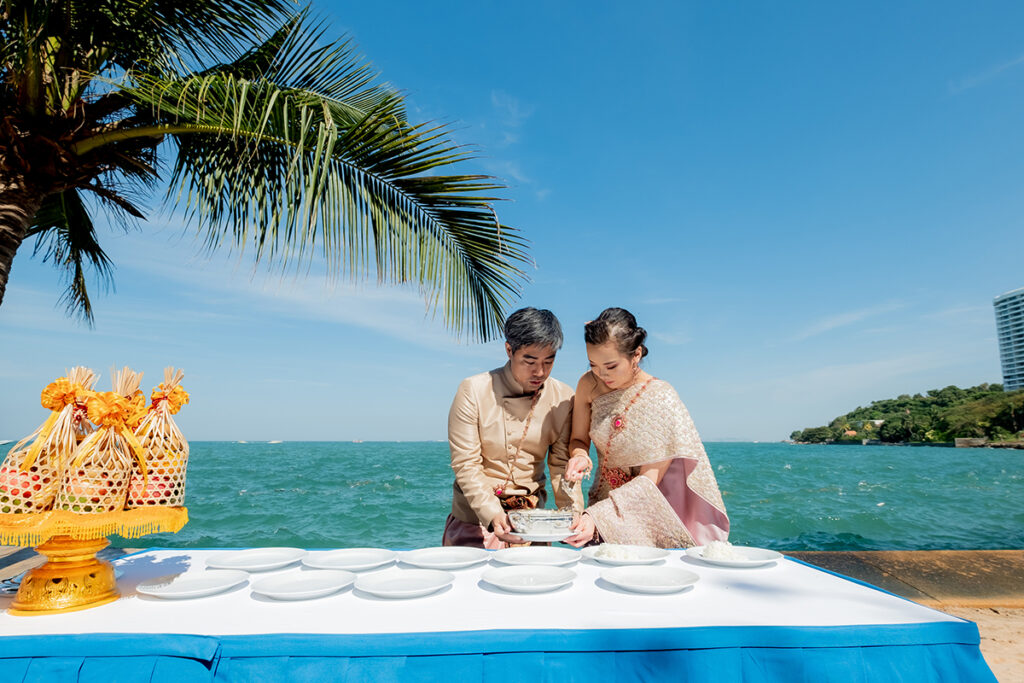 couple having a Thai wedding on the beach