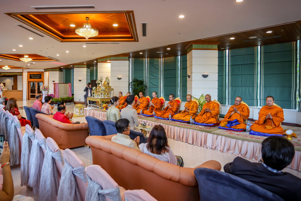 Receiving blessing from the monks before a Thai wedding