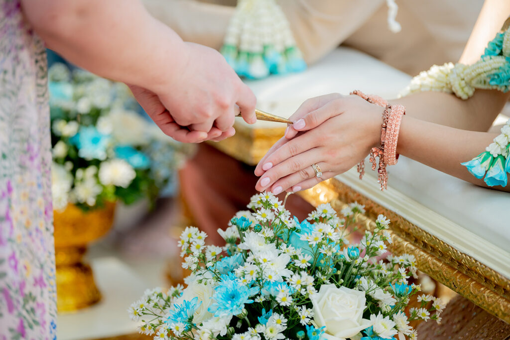 Sacred water poured over hands during the Water Blessing ceremony