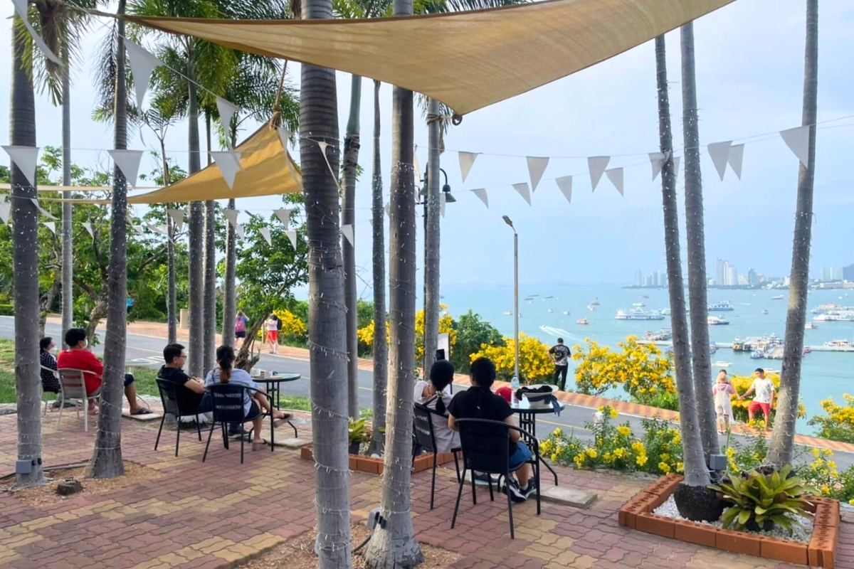 outdoor seating area of cafe in pattaya with bay view