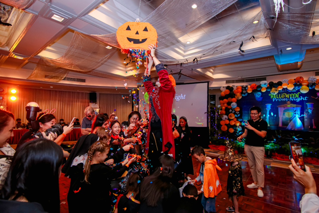 bashing a pinata at a halloween party