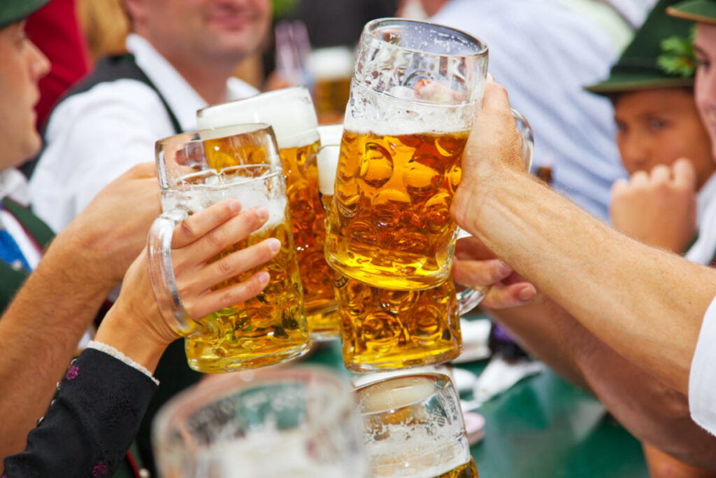 cheerings german beers during oktoberfest 2024