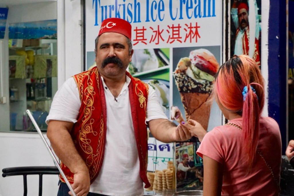 vendor serving turkish ice cream to woman