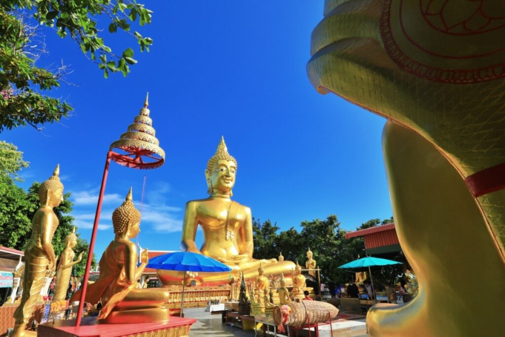 big buddha pattaya surrounded by smaller buddha statues at wat phra yai