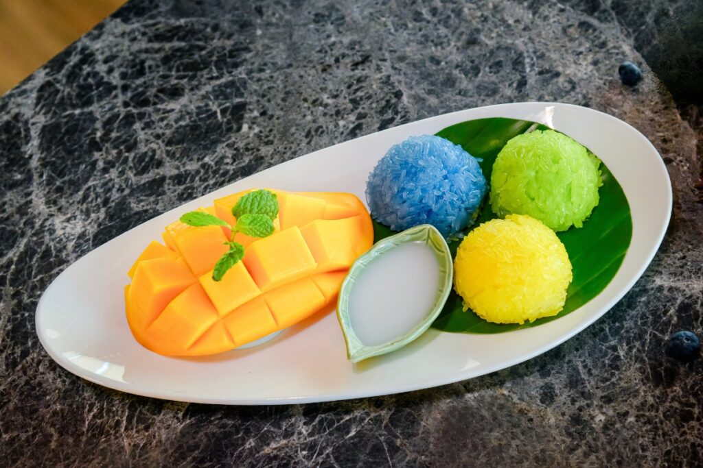 mango sticky rice with multi-colored rice