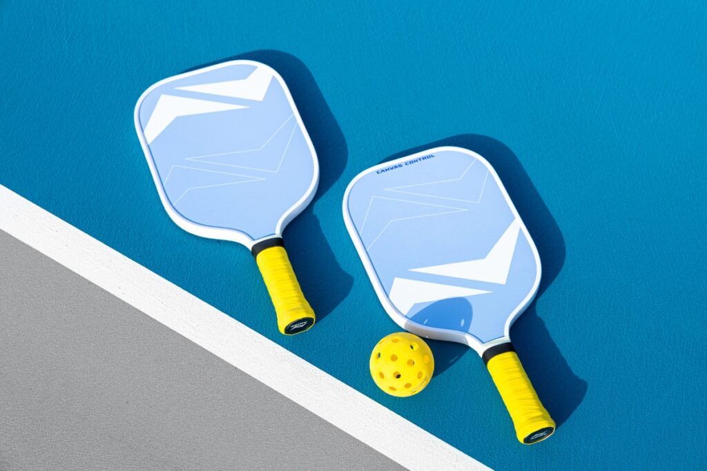 Pickleball paddles with perforated ball