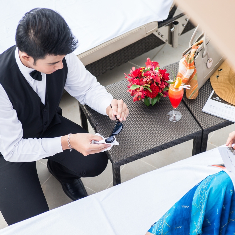 hotel butler cleaning sunglasses at luxury pattaya hotel